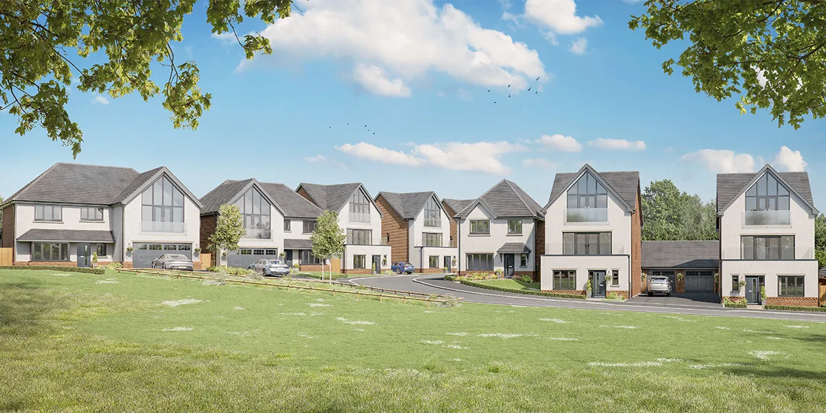 A row of new build homes by Anwyl Homes with modern, two-storey designs and large front windows, set against a bright blue sky and surrounded by a grassy open area.