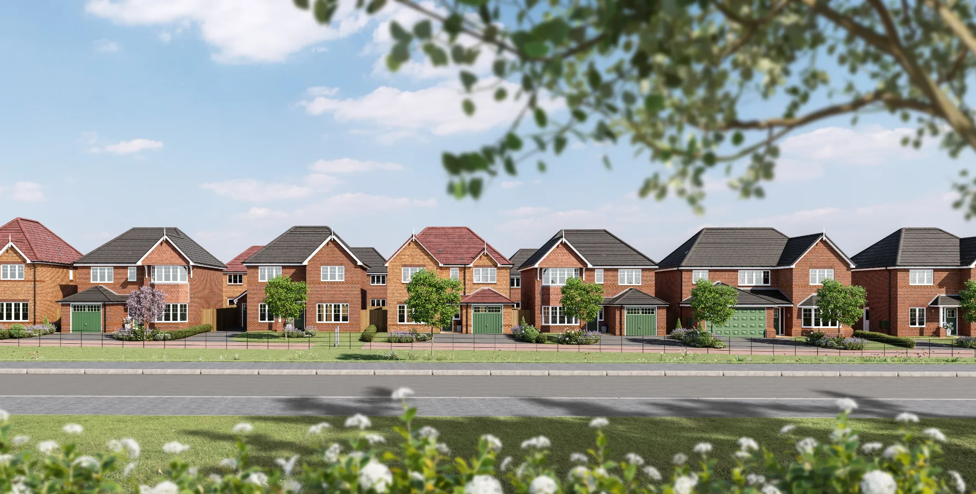 A row of Anwyl Homes new build homes features red brick exteriors with gabled roofs and green garages, set on neatly landscaped lawns with trees and a clear sky overhead.