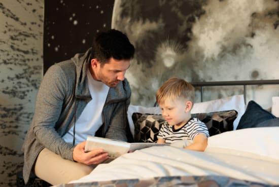 Father reading story to son in bed