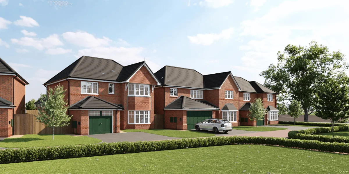 A row of new build homes by Anwyl Homes, featuring red brick exteriors, green garages, and well-maintained lawns, set against a backdrop of trees and a clear sky.