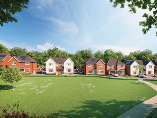 A row of Anwyl Homes’ new build houses, featuring both redbrick and cream facades, sits alongside a spacious green lawn with a few trees, under a bright blue sky.